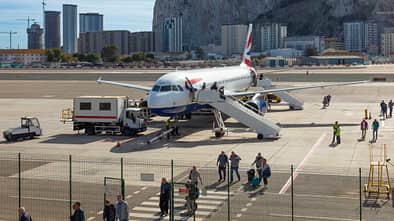 Passengers leaving a British Airways Airbus A320-232 at Gibraltar Airport