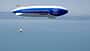Technoflug Piccolo, Zeppelin NT, Luftschiff, Leichtflugzeug, ZF, Bodensee, Luftfahrt, Luftbild, Next Generation Mobility, 2024 Technoflug Piccolo und Zeppelin NT in der Luft über einem See, vermutlich Bodensee, aus der Luft fotografiert. Das Luftschiff trägt die Aufschrift 'Next Generation Mobility. ZF NOW.' und ein einmotoriges Leichtflugzeug (Technoflug Piccolo) fliegt darunter.